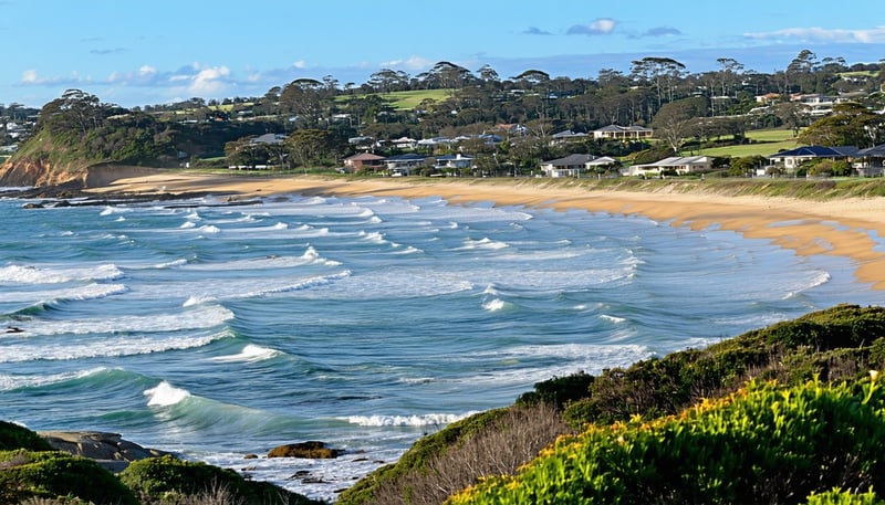 A panoramic view of the Illawarra coastline, showcasing the stunning beachside suburbs ideal for relocation. A panoramic view of the Illawarra coastline, showcasing the stunning beachside suburbs ideal for relocation.